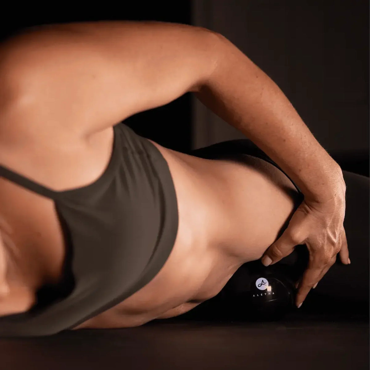 Person using a massage roller on their leg with a blurred background