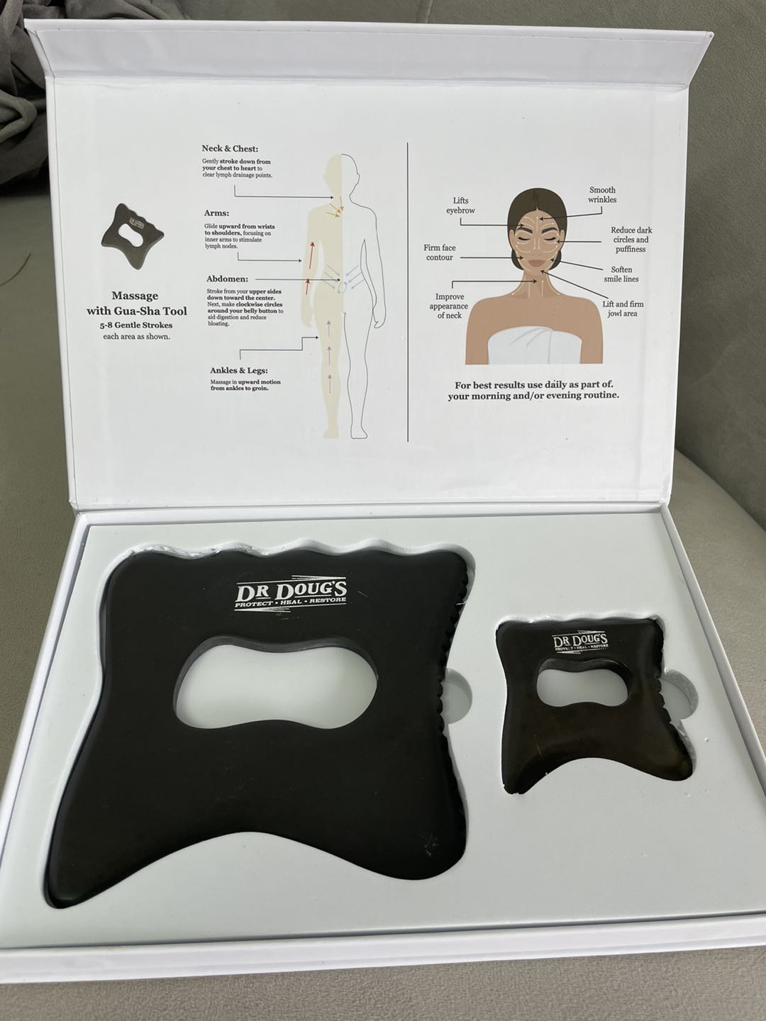 Dr. Doug's massage tool set in a box with instructions on a neutral background